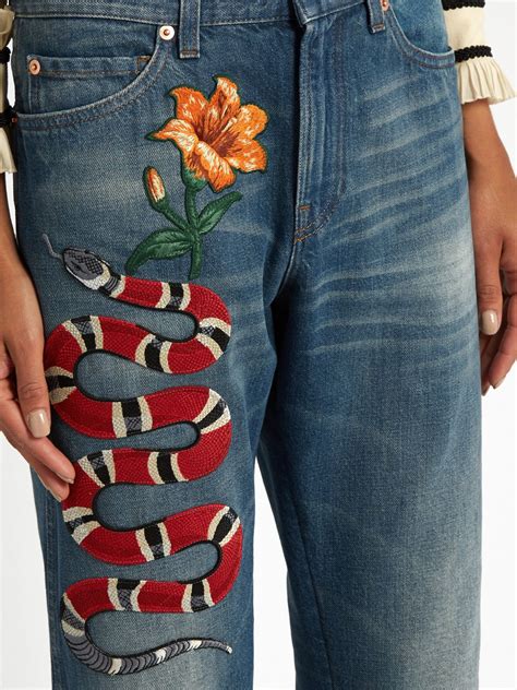 gucci stripe ripped jeans|Gucci snake embroidered jeans.